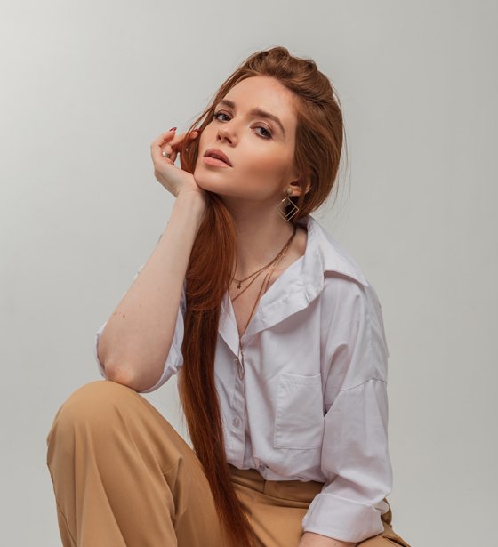 Miembro del equipo creativo de Agencia Fansly posando en estudio con estilo profesional